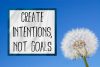 dandelion-on-blue-sky-with-title-that-says-create-intentions-not-goals